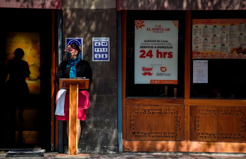 A restaurant employee waits for customers in Mexico City. AFP
