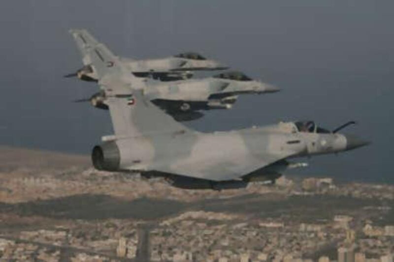 Two of the UAE Air Force's new F-16 Block 60 fighters flying behind a French-made MIrage jet fighter.