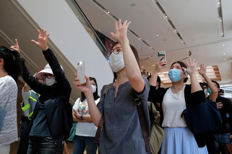 Protesters gesture with five fingers, signifying the "Five demands - not one less" in a shopping mall during a protest in Hong Kong. Protesters in Hong Kong got its government to withdraw extradition legislation last year, but now they're getting a more dreaded national security law. And the message from Beijing is that protest is futile. AP Photo