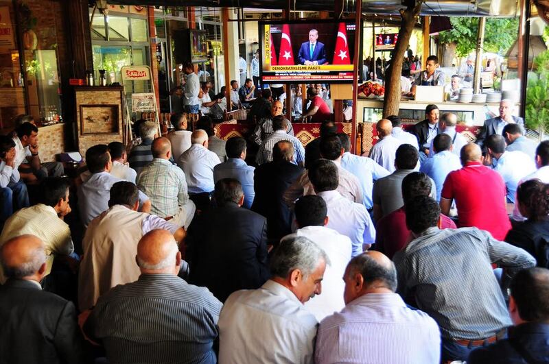 Kurdish people listen to Turkish prime minister Recep Tayyip Erdogan announcing reforms to their rights on TV, in Diyarbakir. Mehmet Engin / AFP 