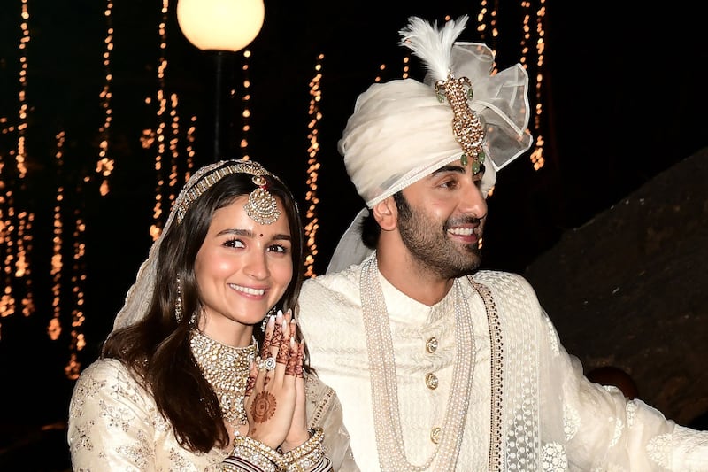 Bollywood actors Alia Bhatt and Ranbir Kapoor greet the media after their wedding in Mumbai on April 14, 2022. AFP