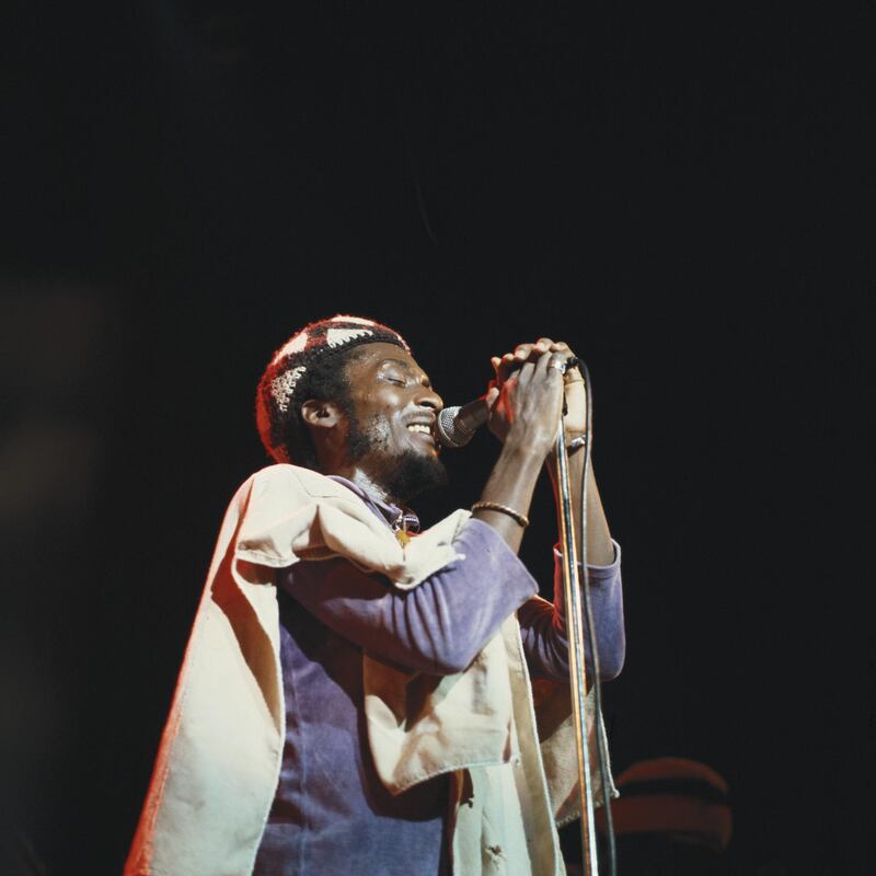 Jimmy Cliff, Jamaican ska and reggae singer, singing into a microphone during a live concert performance on stage at the Hammersmith Odeon in London, England, Great Britain, in November 1978. (Photo by David Redfern/Redferns/Getty Images)