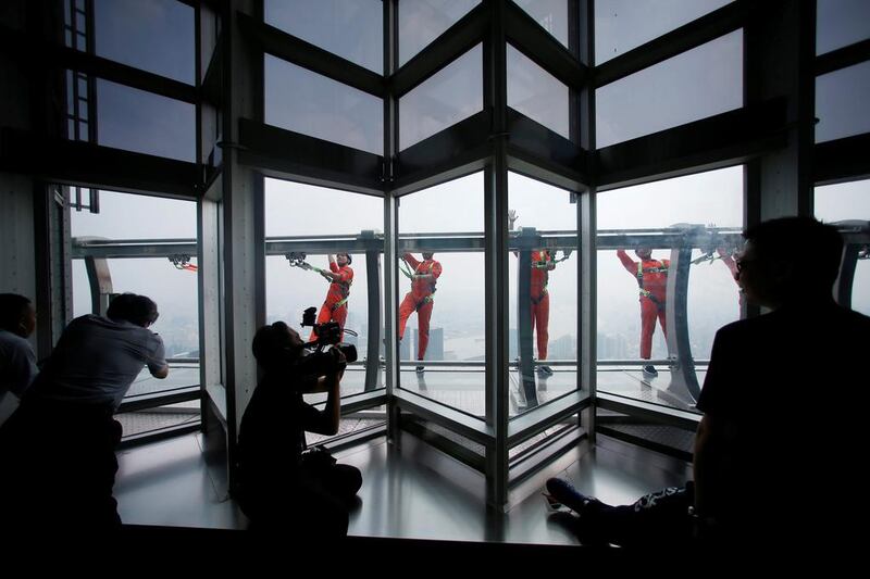 Jin Mao employees walk 340 meters above the ground around the newly opened Jin Mao tower skywalk in Shanghai, China. Aly Song / Reuters