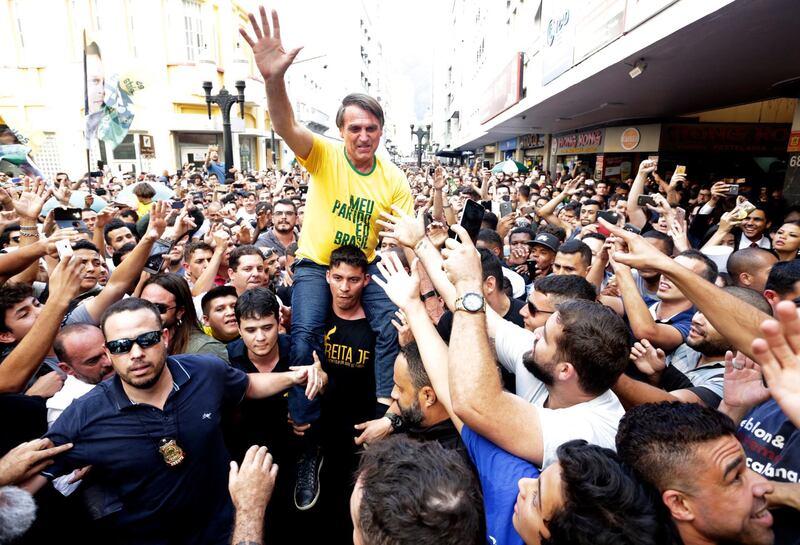 Presidential candidate Jair Bolsonaro is taken on the shoulders of a supporter moments before being stabbed during a campaign rally in Juiz de Fora, Brazil, Thursday, Aug. 6, 2018. Bolsonaro's son said the injury is not life-threatening. (Antonio Scorza/Agencia O Globo via AP)