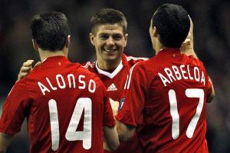 Steven Gerrard celebrates with Xabi Alonso (left) and Álvaro Arbeloa after scoring Liverpool's third.