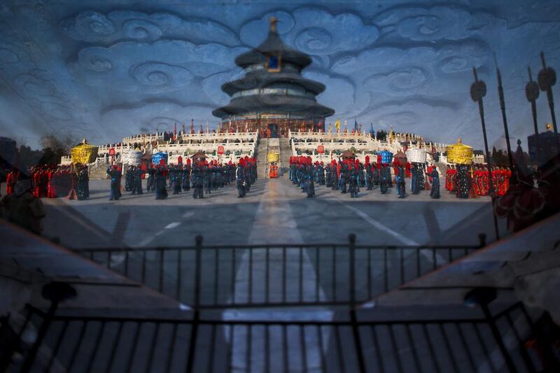 A reflection off glass shows Chinese performers dressed as an imperial entourage as they rehearse a recreation of the Sacrifice to Heaven ritual ahead of the Lunar New Year, or Spring Festival, at the Temple of Heaven in Beijing, China, on January 28, 2014. The Year of the Horse begins January 31, 2014. Diego Azubel / EPA photo