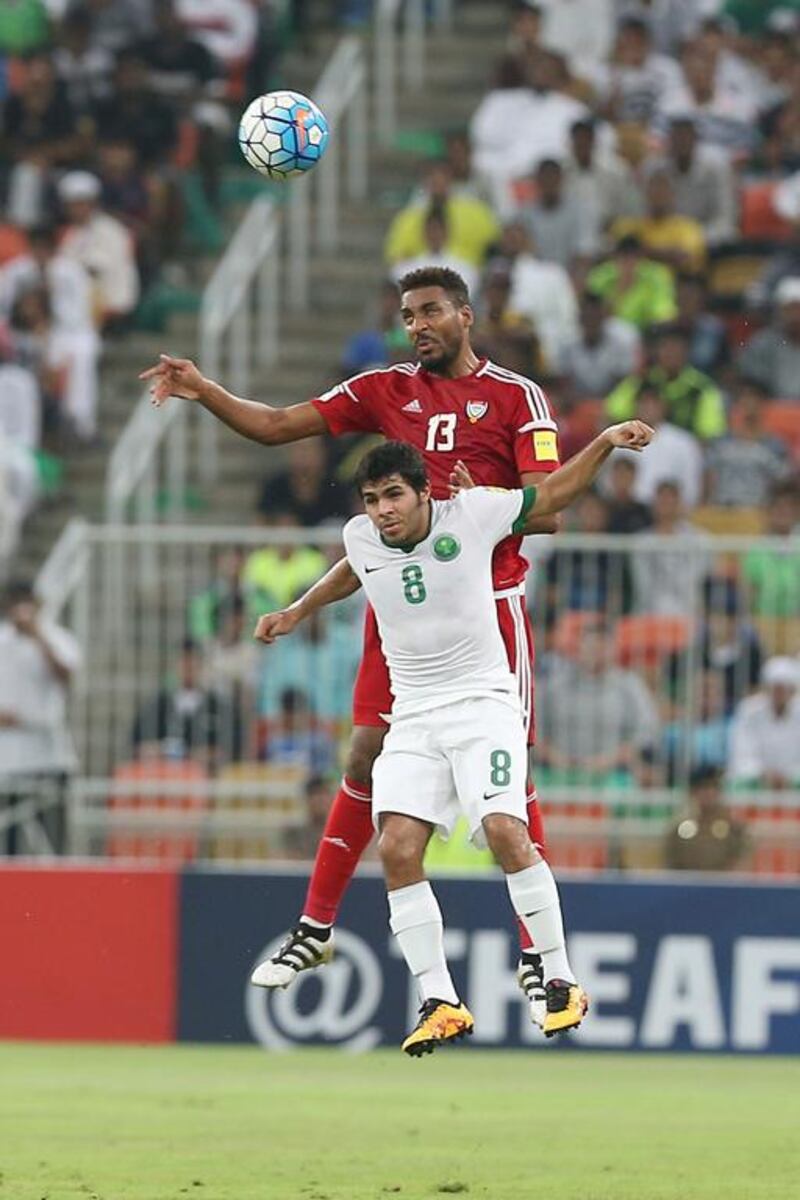 Khamis Esmail of the UAE and Yahya Al Shehri of Saudi Arabia leap for the ball.