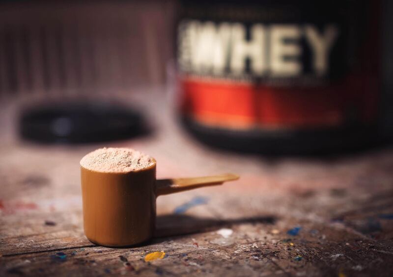Close-Up Of Protein Powder In Scoop On Table. Getty Images