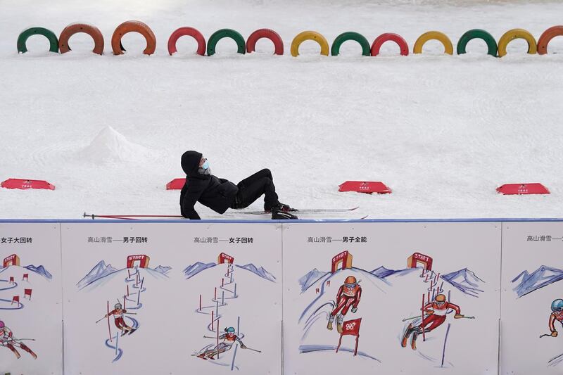 A man falls while skiing at a shopping mall in Beijing, China. AP Photo