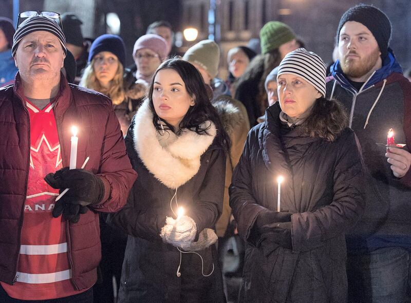 People attend a vigil for victims of Sunday's shooting at a Quebec City mosque, at the Grand Parade in Halifax, Nova Scotia, Monday, Jan. 30, 2017. The 27-year-old suspect in the attack against Muslims at the Quebec City mosque was charged Monday with six counts of first degree murder and five counts of attempted murder. (Andrew Vaughan/The Canadian Press via AP)