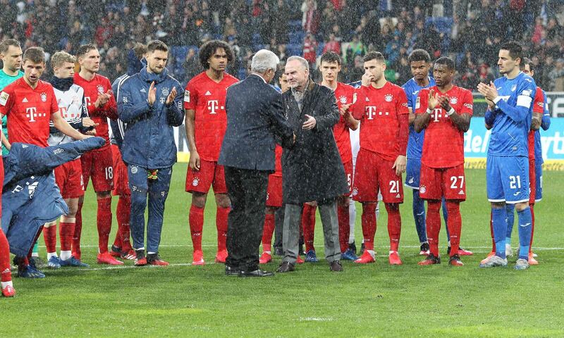 Hoffenheim's chief financial backer Dietmar Hopp, centre left, shakes hands with Bayern Munich's CEO Karl-Heinz Rummenigge after the match. AFP