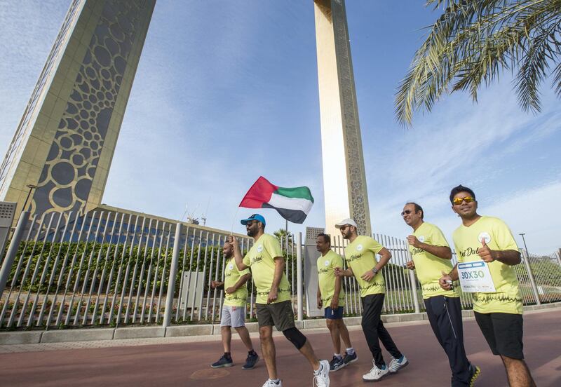 Dubai, United Arab Emirates - Participants  from a company with the UAE flag at the Dubai Run, The Frame Zabeel Park.  Leslie Pableo for The National
