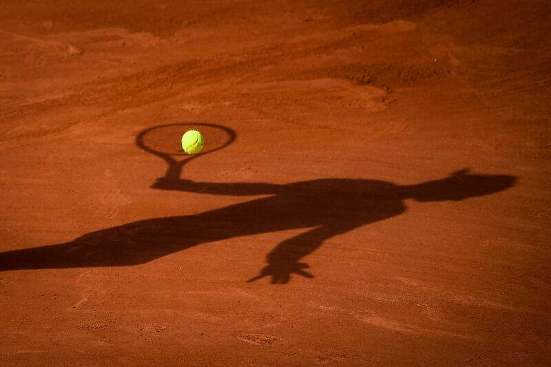 The shadow of Spain's Rafael Nadal is pictured as he returns the ball during his win against Cameron Norrie in the French Open third round at Roland Garros on June 5. AFP