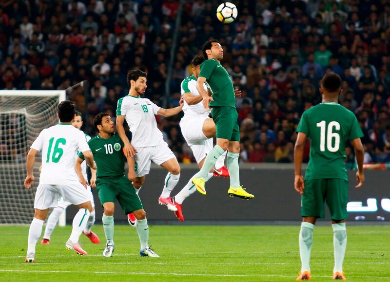 Saudi Arabia and Iraq players vie for the ball. Haidar Mohammed Ali / AFP