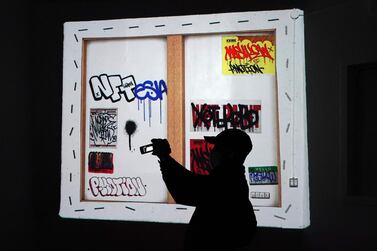 A person takes a photo during the opening of Superchief Gallery NFT, a physical gallery dedicated exclusively to non-fungible tokens artwork in New York. Photo: AFP