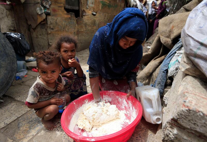 A 'Muhamasheen' woman cooks outdoors in the slums of Sanaa. AFP