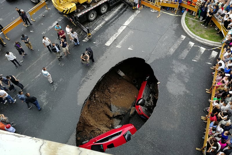 Two cars fell in a sinkhole in Harbin, China, in 2018. Reuters