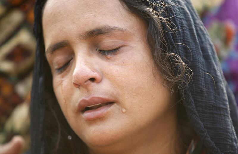 A relative of Akram Hussain, a civilian killed in gunfire allegedly from the Pakistan side of the border, weeps at her village in Ranbir Singh Pura region, about 35 kilometers from Jammu, India on August 25, 2014. Channi Anand/AFP Photo