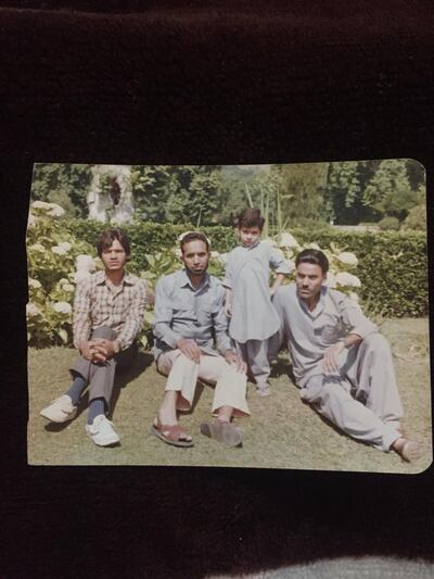 Akram with his father, far right, and friends at a picnic in Tral, Pulwama. Photo: Supplied