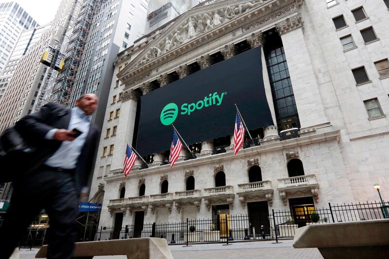 A Spotify banner adorns the facade of the New York Stock Exchange, Tuesday, April 3, 2018. Spotify, the No. 1 music streaming service which has drawn comparisons to Netflix, is about to find out how it plays on the stock market in an unusual IPO. (AP Photo/Richard Drew)