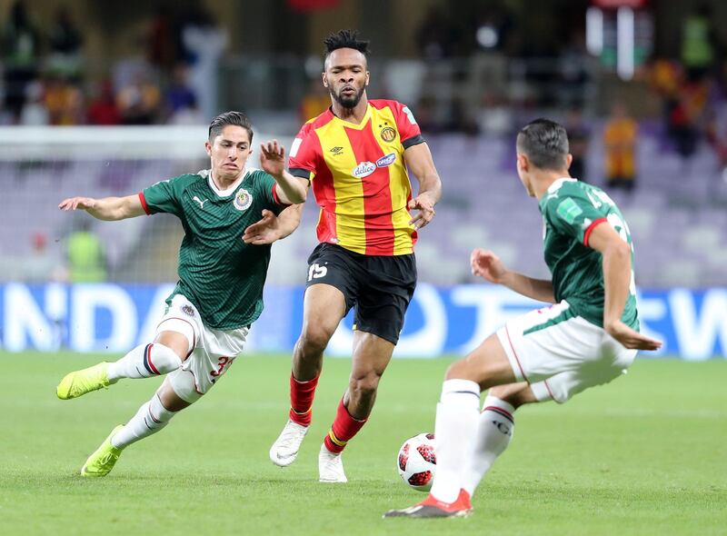 Al Ain, United Arab Emirates - December 18, 2018: Alan Cervantes of Espérance and Fousseny Coulibaly of Guadalajara compete during the game between Espérance de Tunis and Guadalajara in the Fifa Club World Cup. Tuesday the 18th of December 2018 at the Hazza Bin Zayed Stadium, Al Ain. Chris Whiteoak / The National