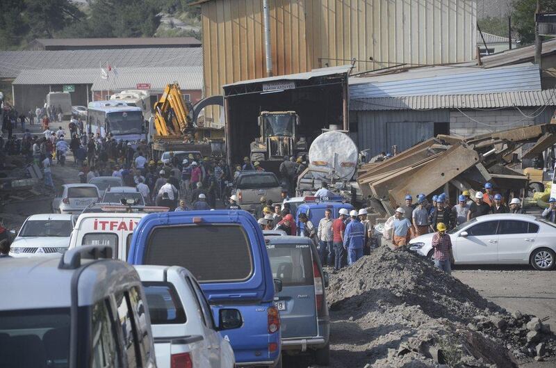 Search and rescue teams and officials are seen around a coal mine where miners are trapped inside. Ihlas / Yilmaz Saripinar / Reuters