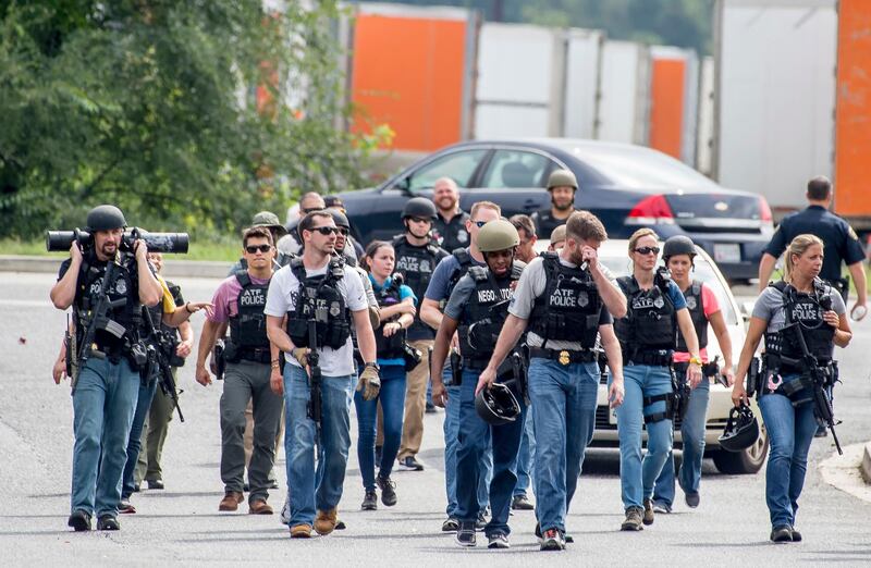 epa07035153 Numerous Bureau of Alcohol, Tobacco, Firearms and Explosives (ATF) agents on patrol after clearning an area near a warehouse as police search for a gunman who fled the scene of a shooting at a Rite Aid Distribution Center in Aberdeen, Maryland, USA, 20 September 2018. Media reports indicate numerous casualties in the shooting.  EPA/SCOTT SERIO