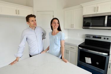 Andy and Stacie Proctor stand in their new home in Utah in the US. For some millennials looking to buy their first home, the hunt feels like a race against the clock. AP