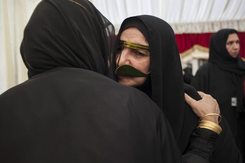 Umm Tariq Al Shehi is greeted by women upon arriving at an event to honour mothers of UAE soldiers killed during service. Razan Alzayani for The National
