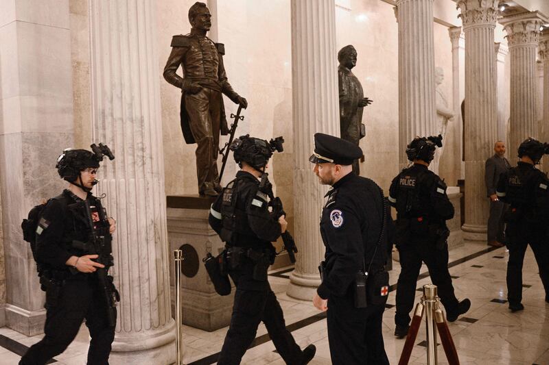 Members of a Secret Service team depart the Capitol after the State of the Union speech. AFP