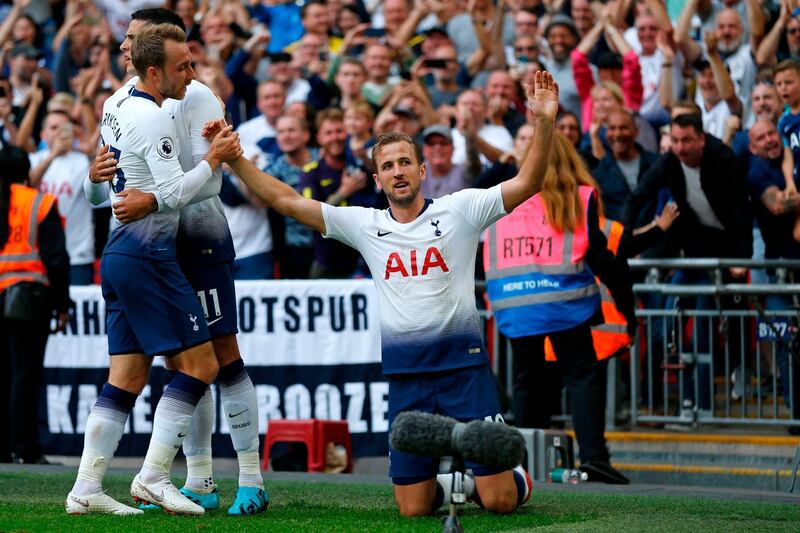 Tottenham Hotspur's English striker Harry Kane (C) celebrates after scoring their third goal during the English Premier League football match between Tottenham Hotspur and Fulham at Wembley Stadium in London, on August 18, 2018. (Photo by Ian KINGTON / AFP) / RESTRICTED TO EDITORIAL USE. No use with unauthorized audio, video, data, fixture lists, club/league logos or 'live' services. Online in-match use limited to 120 images. An additional 40 images may be used in extra time. No video emulation. Social media in-match use limited to 120 images. An additional 40 images may be used in extra time. No use in betting publications, games or single club/league/player publications. / 