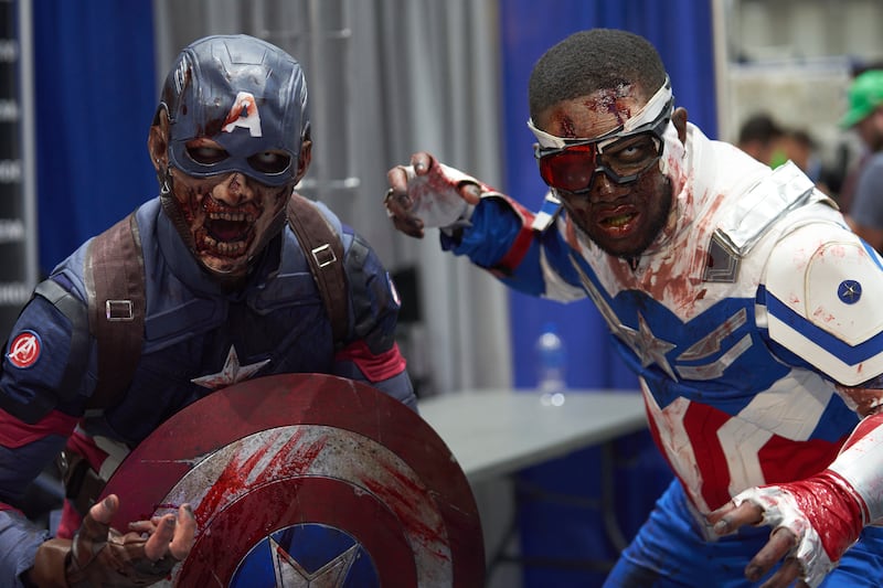From left, two cosplayers as zombie versions of Captain America and Falcon. EPA