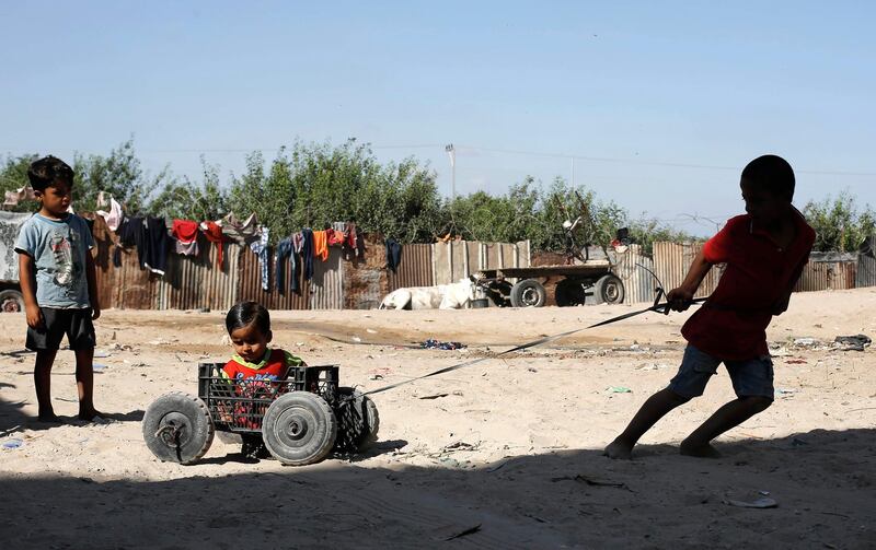 Palestinian children play at an empoverished neighbourhood in Gaza City.  AFP