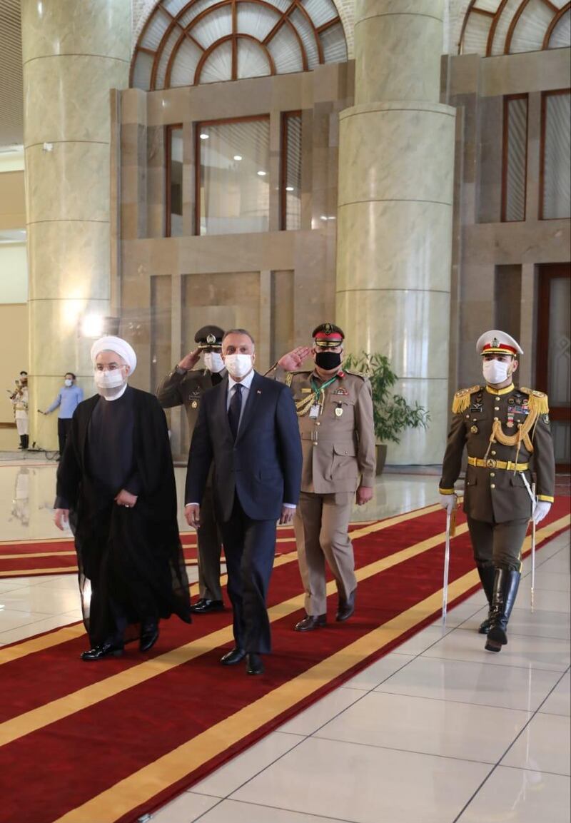 Iranian President Hassan Rouhani welcomes the visiting Iraqi Prime Minister, Mustafa Al Kadhimi. as they wear protective masks, in Tehran, Iran.  Reuters