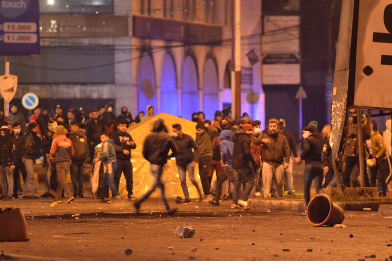 Lebanese anti-government protesters clash with security forces following a demonstration against dire economic conditions in the northern city of Tripoli.  AFP