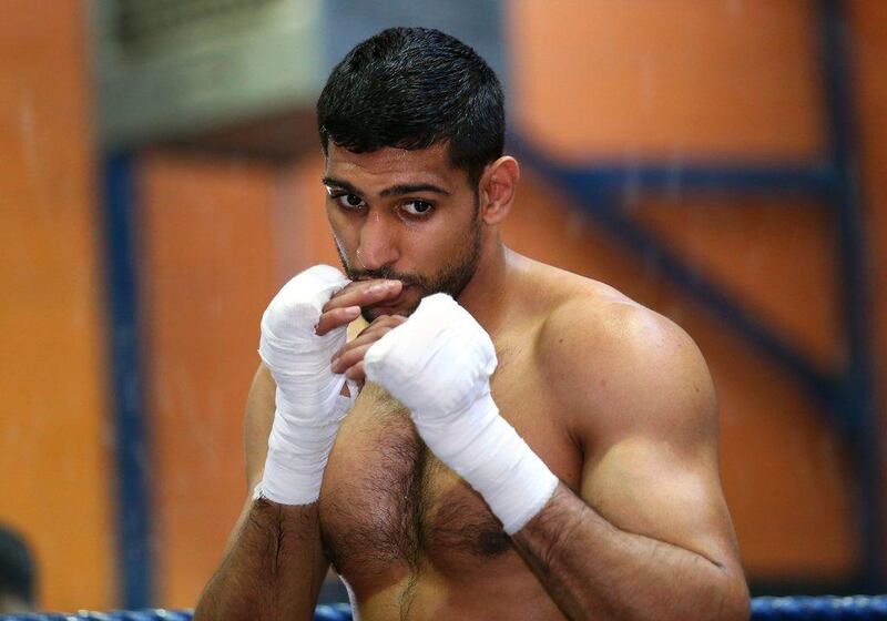 Amir Khan shadow boxes during a workout at the Gloves Community Centre on Monday in Bolton, England. Alex Livesey / Getty Images / March 24, 2014