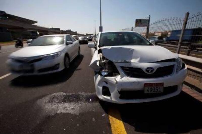 A car that has been in a smash sits at the side of Shiekh Zayed Road near the Oasis Centre in Dubai. Christopher Pike / The National