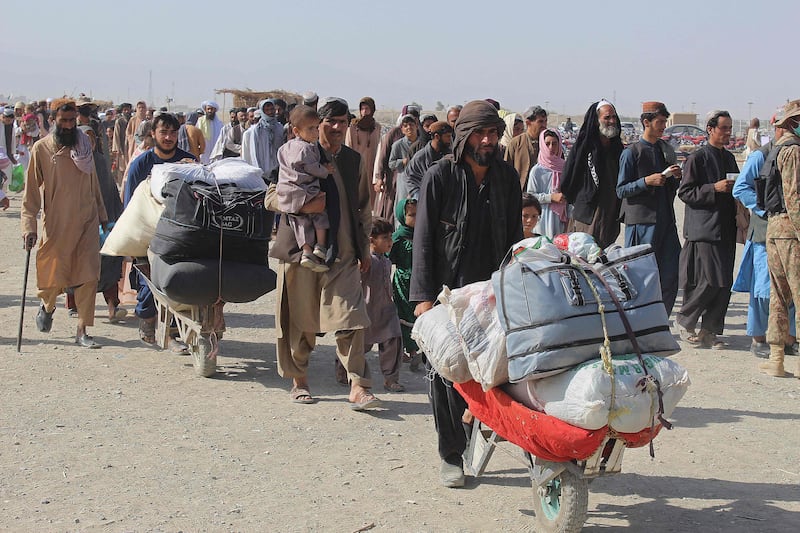 Afghan nationals arrive at the Pakistan-Afghanistan border crossing point in Chaman to return to Afghanistan. AFP