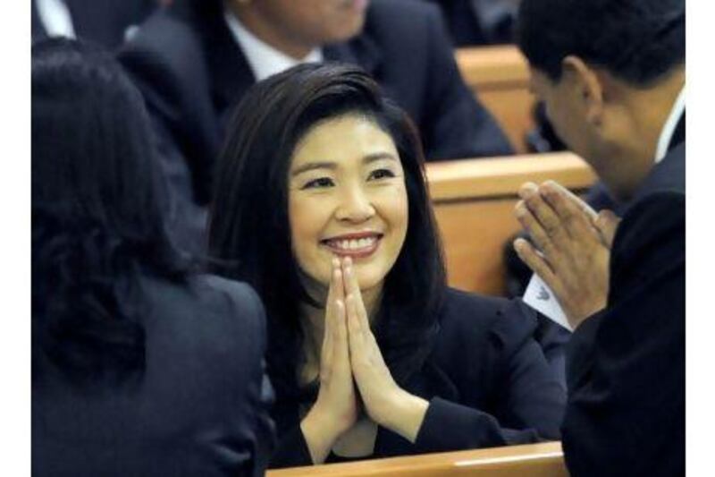 The Thai prime minister-in-waiting, Yingluck Shinawatra, gives a traditional greeting to members of parliament as they attend the vote for a parliamentary speaker in Bangkok yesterday. Pornchai Kittiwongsakul / AFP Photo