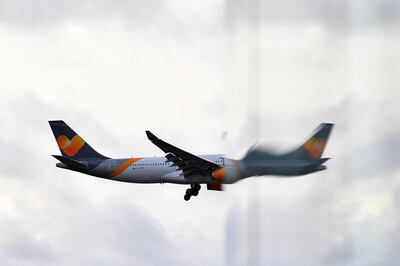 A Thomas Cook Airlines operated Airbus 330 aircraft is reflected in a window as it prepares to land at London Gatwick Airport, south of London, on December 21, 2018, as flights resumed following the closing of the airfield due to a drones flying. British police were Friday considering shooting down the drone that has grounded flights and caused chaos at London's Gatwick Airport, with passengers set to face a third day of disruption. Police said it was a "tactical option" after more than 50 sightings of the device near the airfield since Wednesday night when the runway was first closed. 
 / AFP / Ben STANSALL
