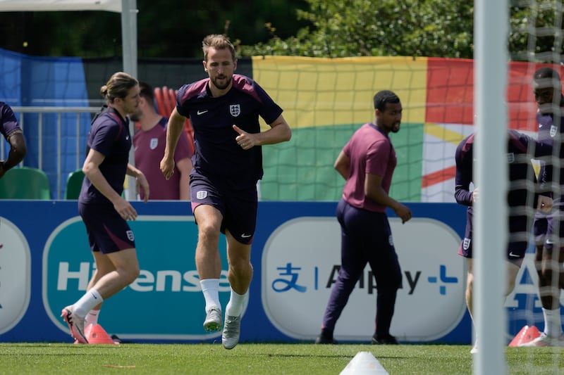 England captain Harry Kane warms up during training in Blankenhain in Germany ahead of their Group C Euro 2024 match against Slovenia. AP