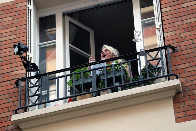 French singer Veronica Antonelli sings from her apartment window in Paris. AP Photo