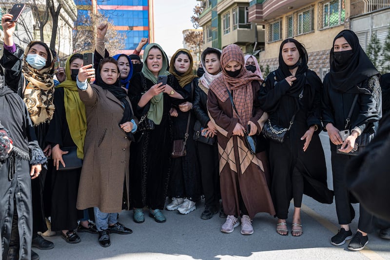 Afghan women stage a protest for their right to mark International Women's Day, in Kabul on March 8. Since taking over in 2021, the Taliban has imposed restrictions on women’s education and employment, including closing high schools and universities for women. AFP