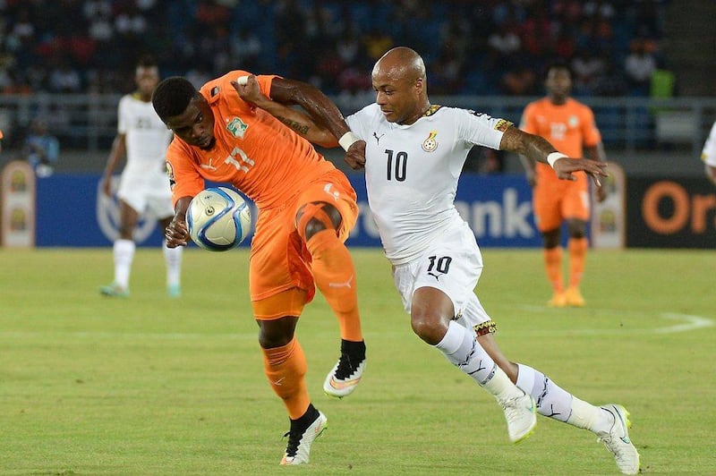 Ghana midfielder Andre Ayew, right, challenges Ivory Coast defender Serge Aurier during the Africa Cup of Nations final on Sunday night. Khaled Desouki / AFP