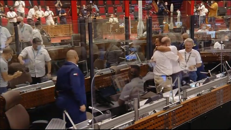 UAE space officials, Russians and the French team celebrate at mission control after successful launch