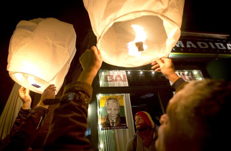 New Yorkers release paper lanterns outside Madiba, a restaurant in Brooklyn named in honour of Nelson Mandela, after hearing of the South African anti-apartheid hero's death on Thursday. Carlo Allegri / Reuters