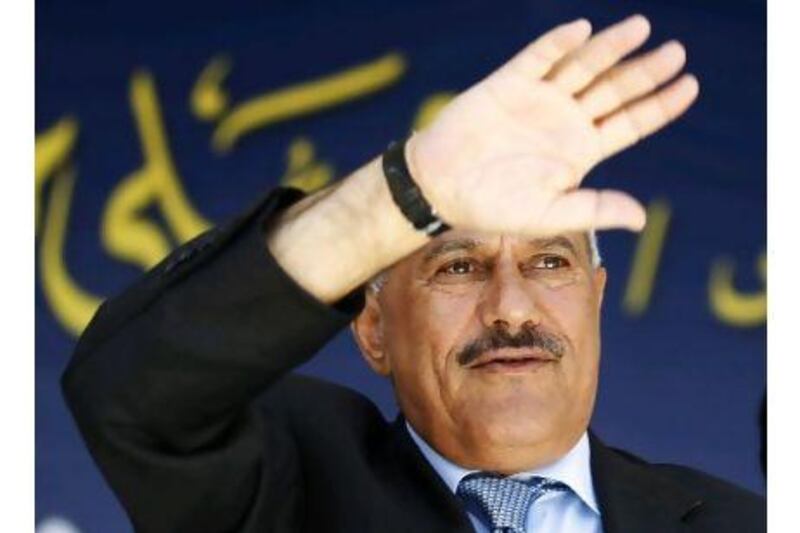 Yemen's President Ali Abdullah Saleh waves to supporters gathered in a soccer stadium where he delivered a speech saying he would draw up a new constitution to create a parliamentary system of government.