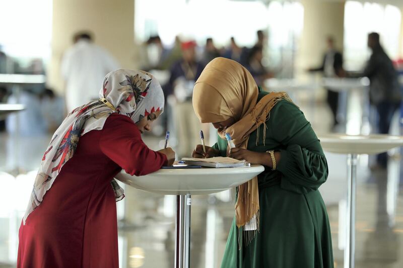 Dubai, United Arab Emirates - March 17, 2019: People study the form and mark their race cards at the Dubai World Cup. Saturday the 30th of March 2019 at Meydan Racecourse, Dubai. Chris Whiteoak / The National