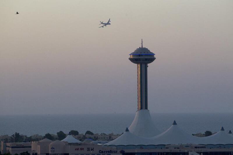 An Etihad airplane flys over the Corniche in Abu Dhabi on November 10, 2013. Christopher Pike / The National

