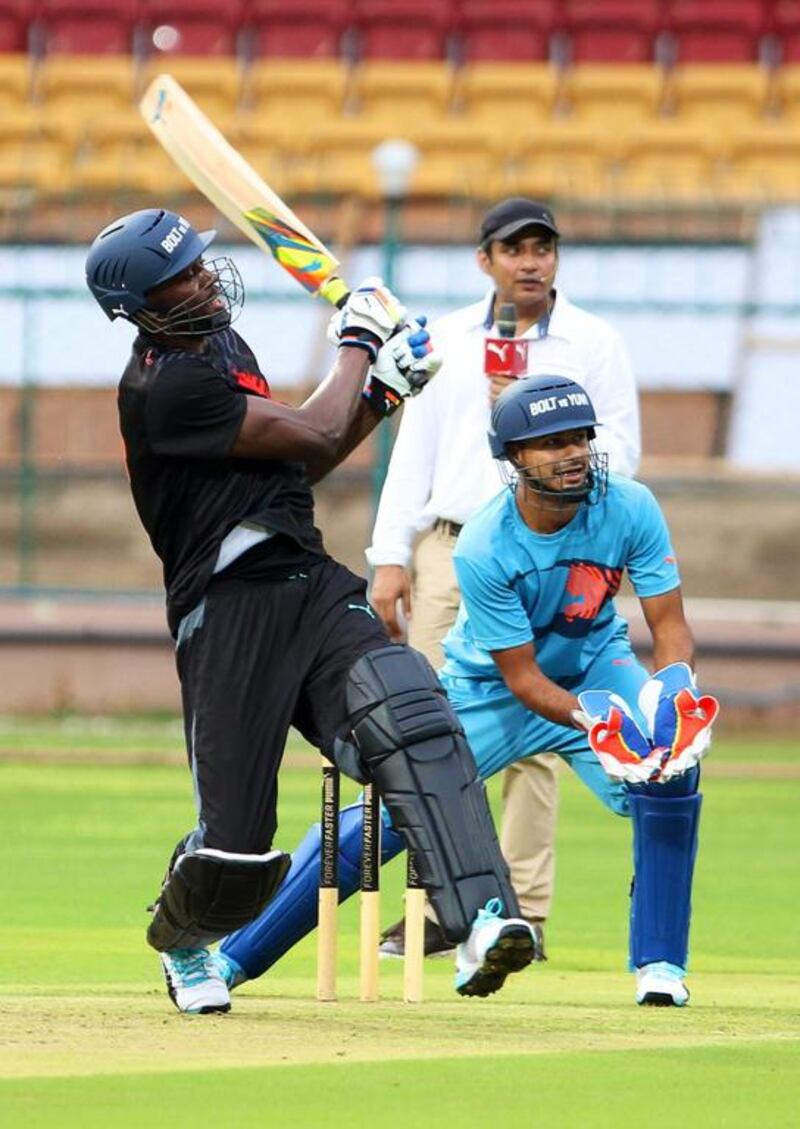 Usain Bolt plays a shot during the exhibition match, formally between Team Usain Bolt and Team Yuvraj Singh, in Bangalore on Tuesday. Jagadeesh NV / EPA